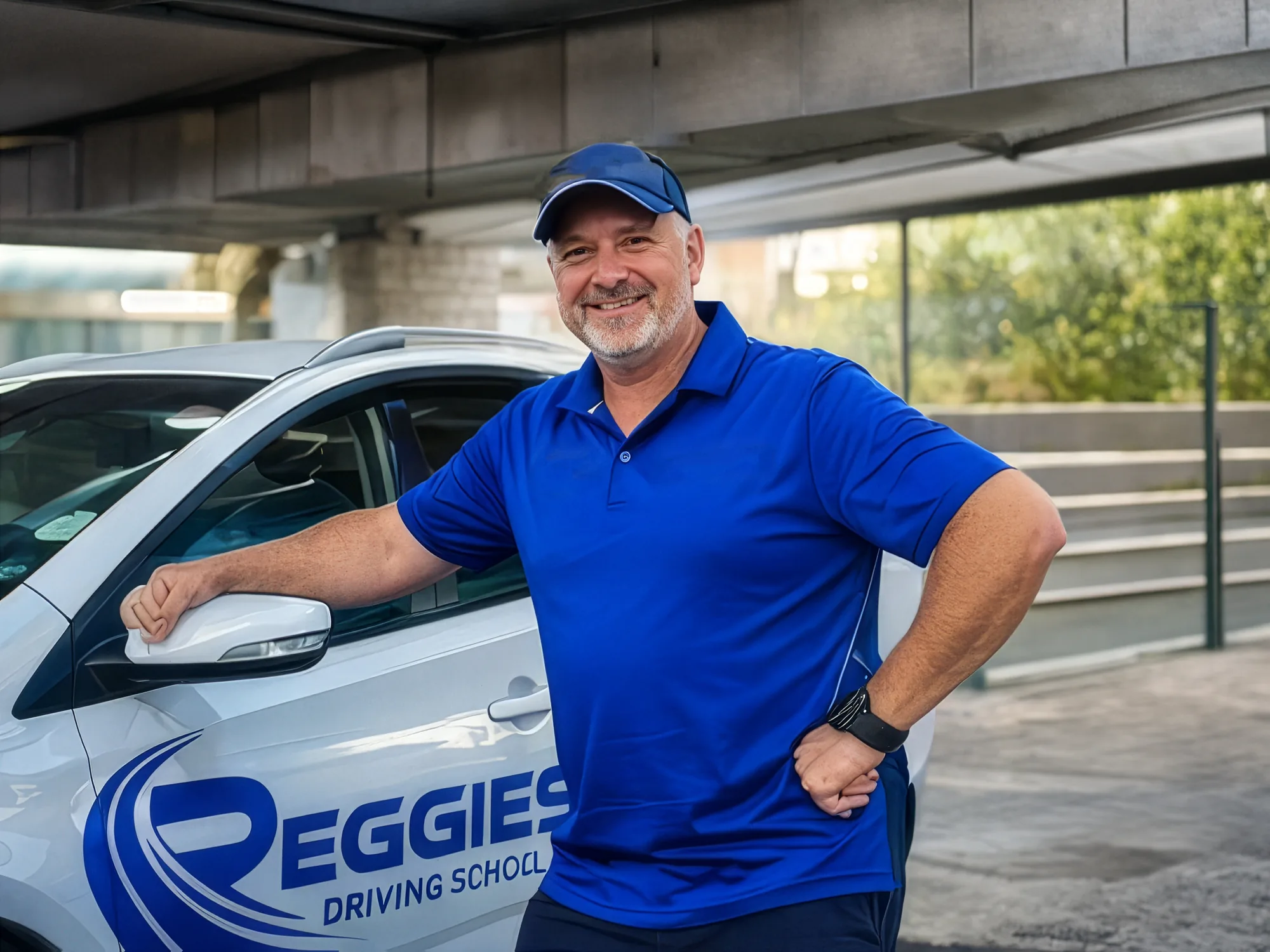 Reggie, owner and driving instructor, standing beside his Reggie's Driving School car